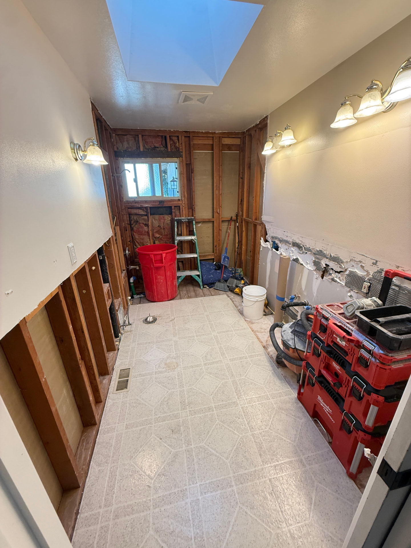 Bathroom during demolition with tools neatly organized and the floor kept clean