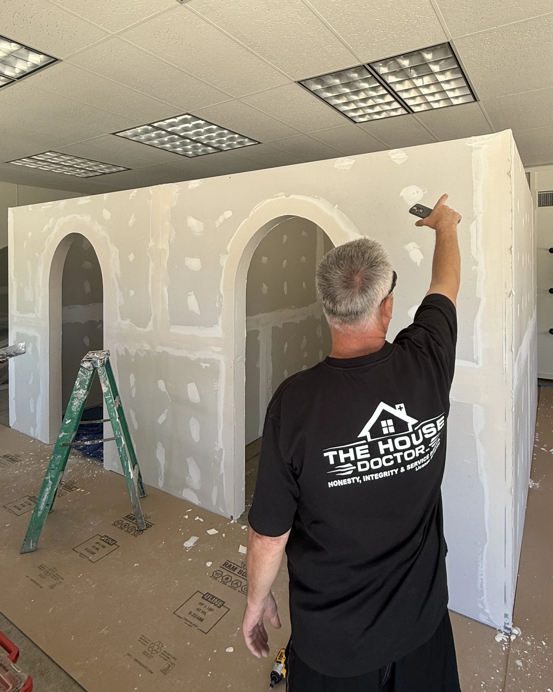 A House Doctor craftsman carefully finishing an interior archway